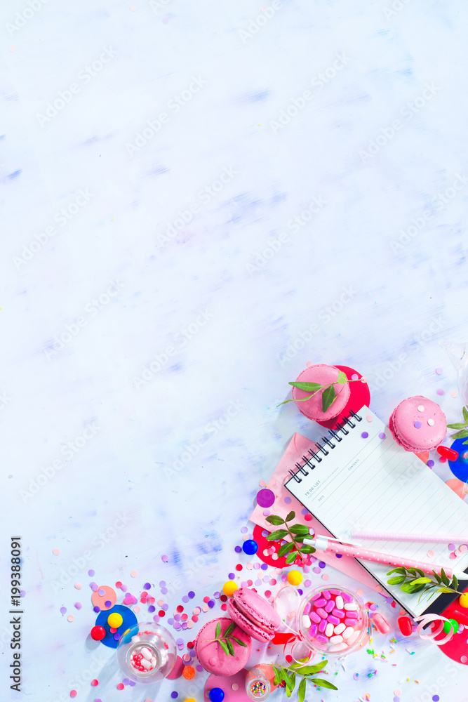 Party management and organization concept with sweets, confetti and an open notepad with blank pages. Creative celebration flat lay with copy space. Party management and organization concept with sweets, confetti and an open notepad with blank pages. Creative celebration flat lay with copy space.