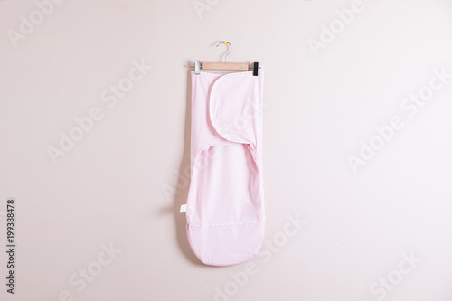 Baby clothes and accessories on wooden background photo