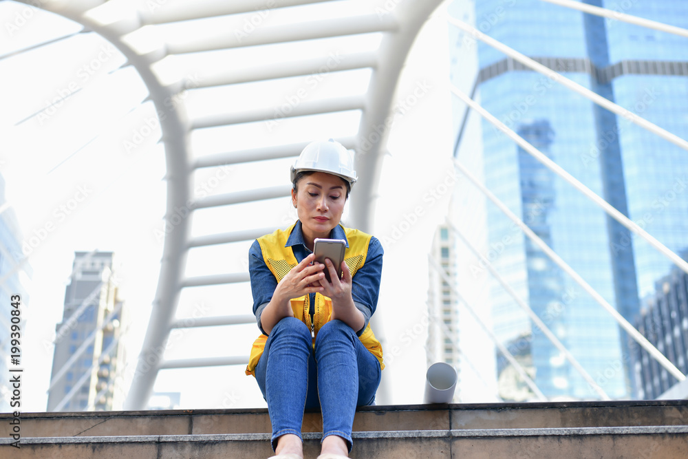 Business Engineering Concepts, Professional engineers, Young Business people are playing mobile phone. Business Engineering Concepts, Professional engineers, Young Business people are playing mobile phone.