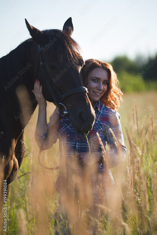 Fototapeta premium Woman and horse together in sunny summer field