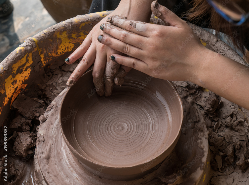 hands of a potter, creating an earthen jar on the circle hands of a potter, creating an earthen jar on the circle
