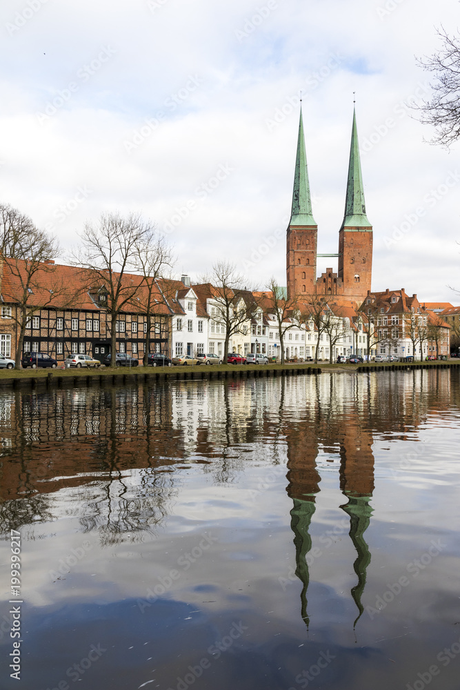 Lubeck, Germany. Views of Lubeck Cathedral (Dom zu Lubeck, Lubecker Dom) reflected in the river Trave. A World Heritage Site since 1987