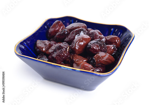 Sun-dried olives with oil and herbs. Isolated photo