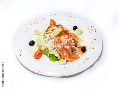 Vegetable salad fish on a white plate