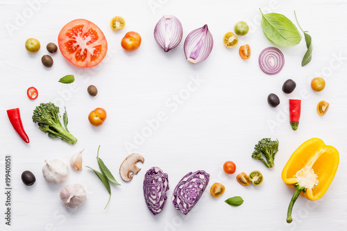 Various fresh vegetables and herbs on white background.Ingredients for cooking concept sweet basil ,tomato ,garlic ,pepper and onion with flat lay..
