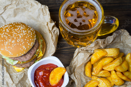 Fast food and a chilled glass of fresh light beer.
