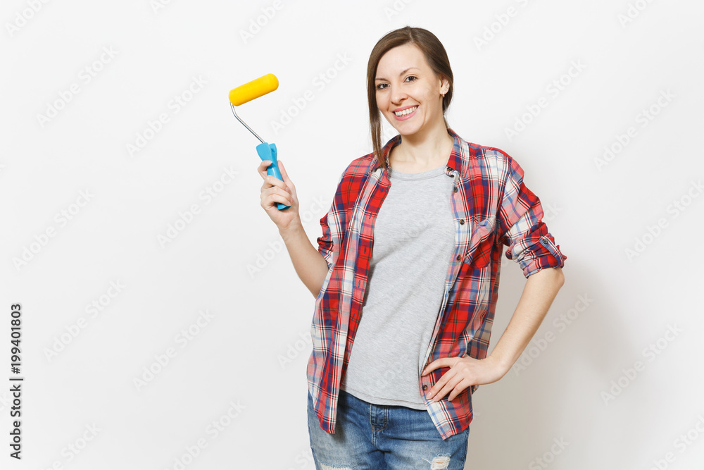 Young smiling beautiful woman in casual clothes holding paint roller for wall painting isolated on white background. Instruments, accessories, tools for renovation apartment room. Repair home concept. Young smiling beautiful woman in casual clothes holding paint roller for wall painting isolated on white background. Instruments, accessories, tools for renovation apartment room. Repair home concept.