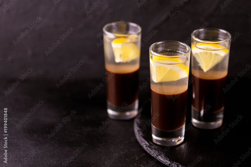 Alcoholic cocktail silver bullet with gin, coffee liqueur and lemon.