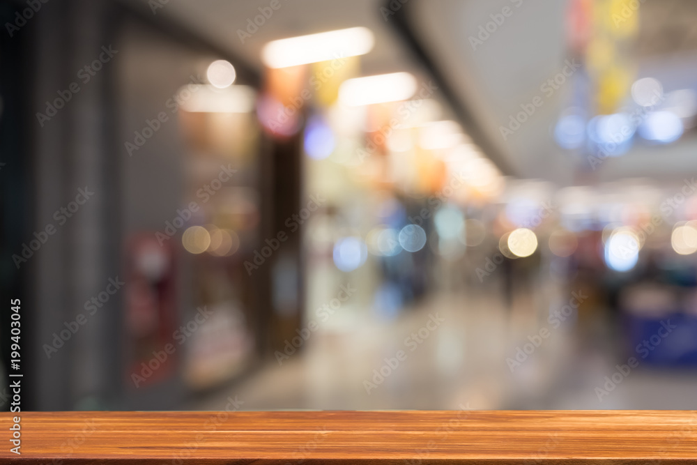Wooden board empty table blurred background. Perspective brown wood table over blur in department store background - can be used for display or montage your products. Mock up for display of product.