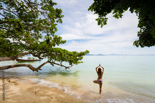 Yoga on tropical thai beach photo