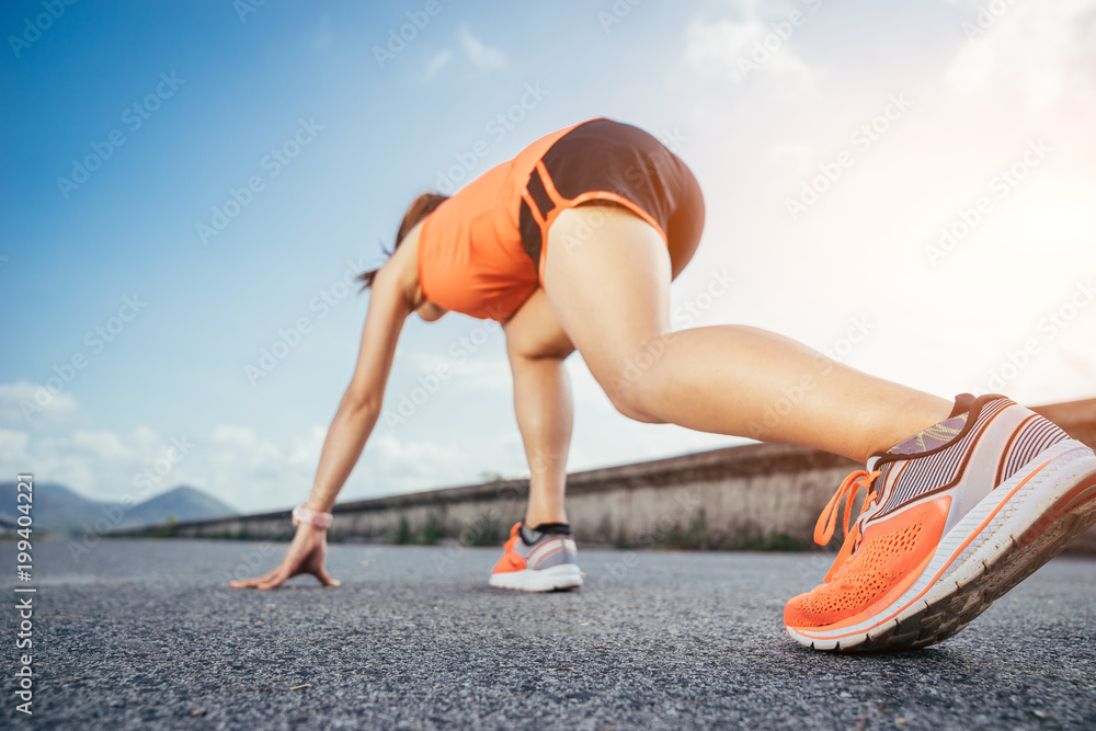An asian woman athletic is jogging on the concrete road, she is warming