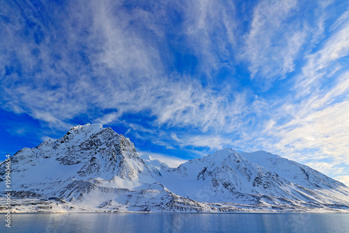 Wallpaper Mural White snowy mountain, blue glacier Svalbard, Norway. Ice in ocean. Iceberg twilight, ocean. Pink clouds with ice floe. Beautiful landscape. Land of ice. Cold blue water nature. Rocky island with snow. Torontodigital.ca