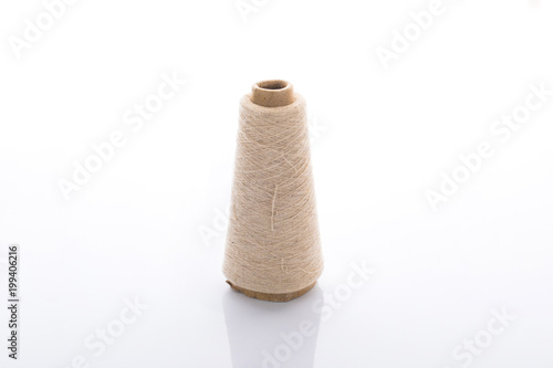 bobbins of the natural fiber, rough flax, isolated on white background
