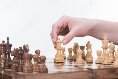 cropped image of businesswoman playing chess isolated on white, business concept