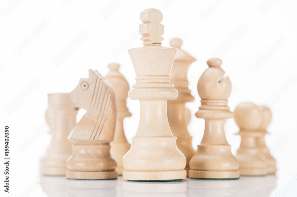 white wooden chess king with knight and bishop on sides on white white wooden chess king with knight and bishop on sides on white