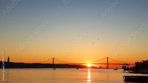 Sunset in Portugal against the backdrop of the bridge © nikolaskus