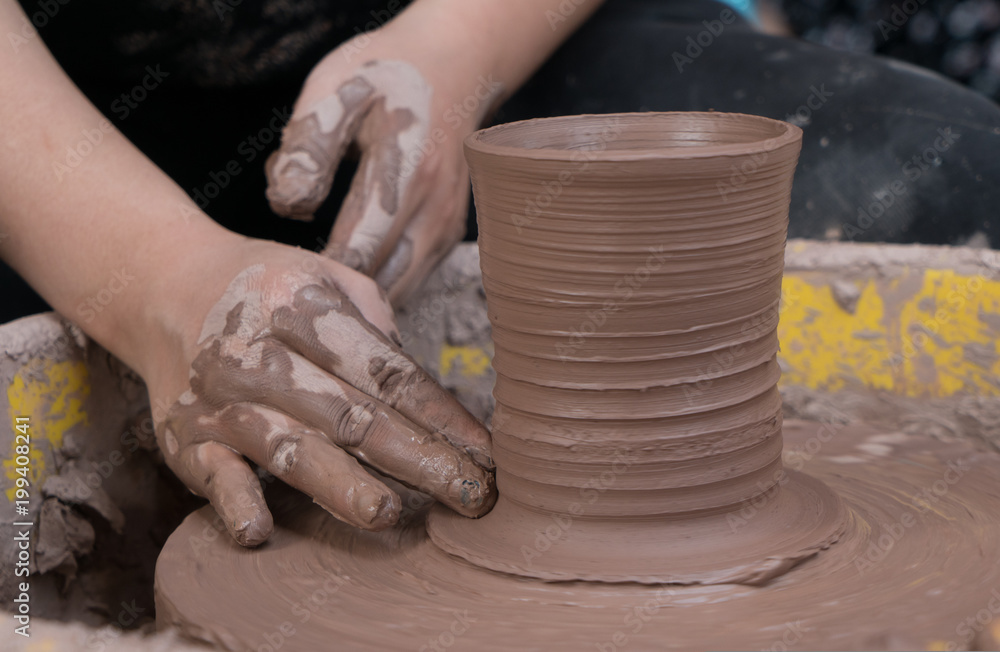 hands of a potter, creating an earthen jar on the circle hands of a potter, creating an earthen jar on the circle