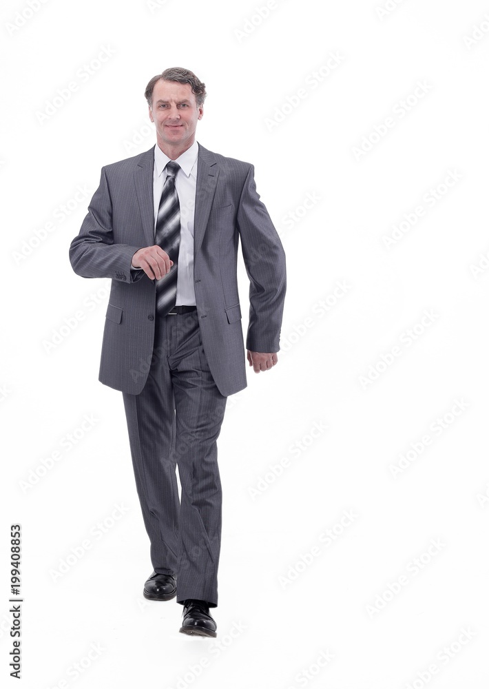 in all growth.a successful businessman, confidently striding forward. in all growth.a successful businessman, confidently striding forward.