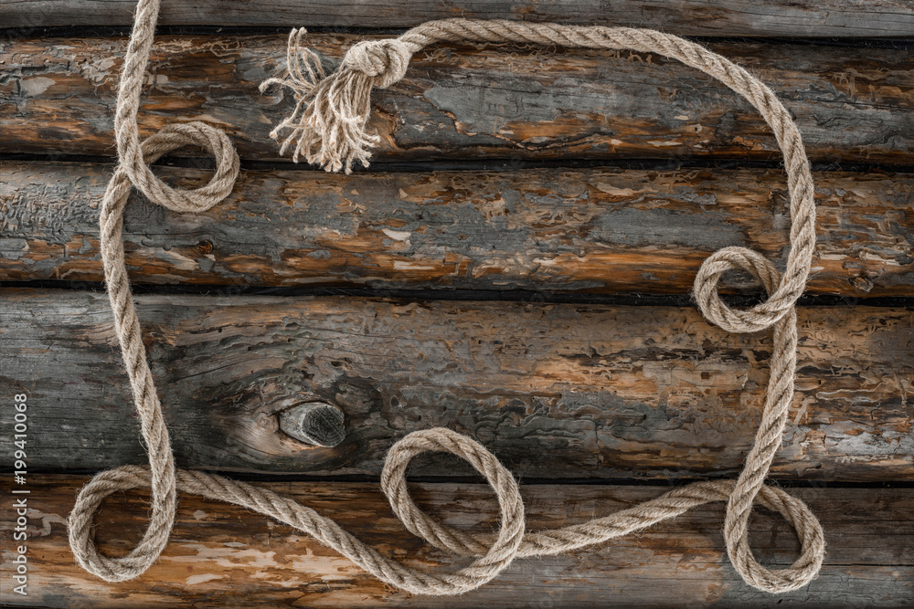 top view of nautical rope with knot on grunge wooden surface