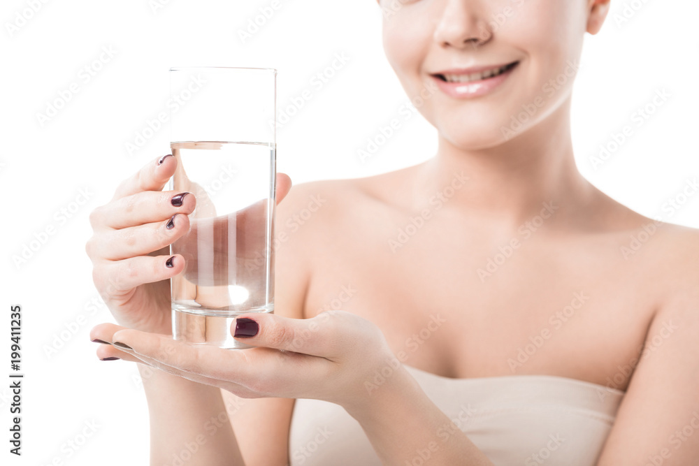cropped image of beautiful smiling girl holding glass of water isolated on white cropped image of beautiful smiling girl holding glass of water isolated on white