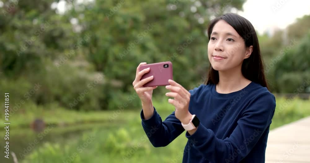 Woman using mobile phone for taking photo and video Woman using mobile phone for taking photo and video