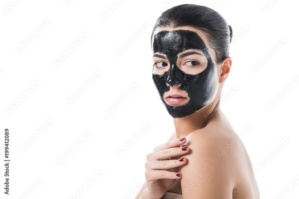 beautiful girl in cosmetic black clay facial mask with naked shoulder isolated on white beautiful girl in cosmetic black clay facial mask with naked shoulder isolated on white