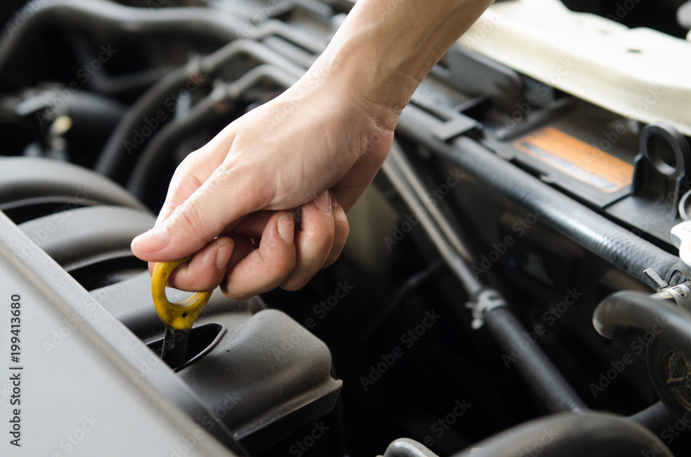 Close up shot hand pull the ring to check oil Close up shot hand pull the ring to check oil
