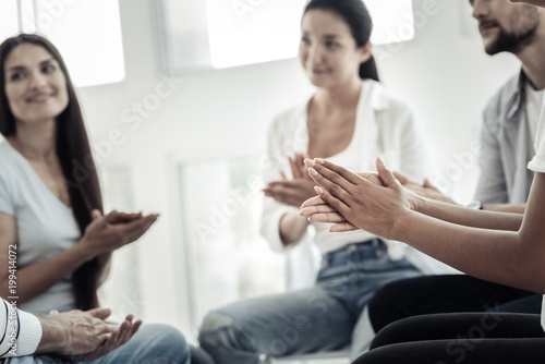 Big applauds. Close up of hands being clapped together while supporting each other in a group