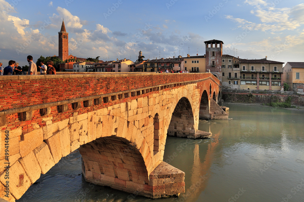 Verona, Italy - Ponte Pietra bridge over Adige river with Verona historic city center panoramic view in the background