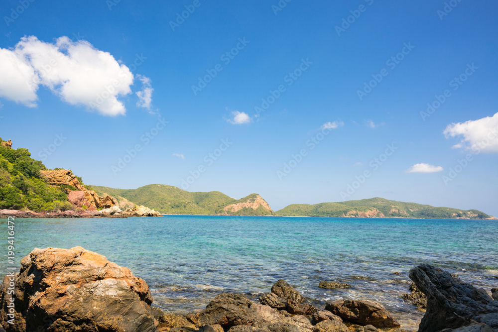 Fototapeta premium Beautiful white clouds on blue sky over calm sea with sunlight reflection