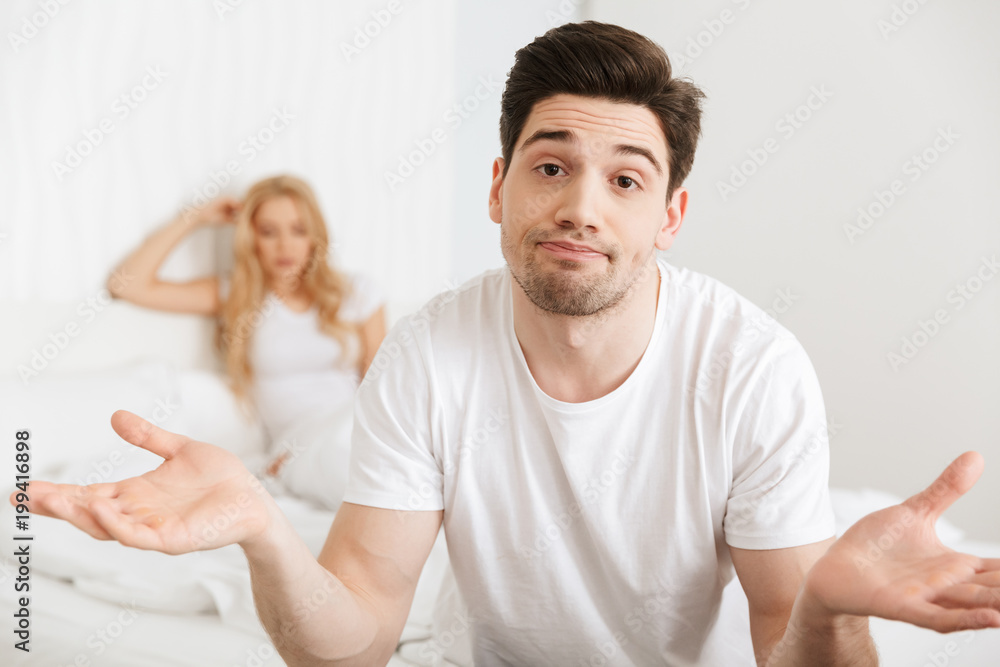 Loving couple in bed indoors at home Loving couple in bed indoors at home