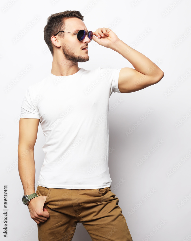 Elegant young handsome manin smart casual wear and sunglasses. Elegant young handsome manin smart casual wear and sunglasses.