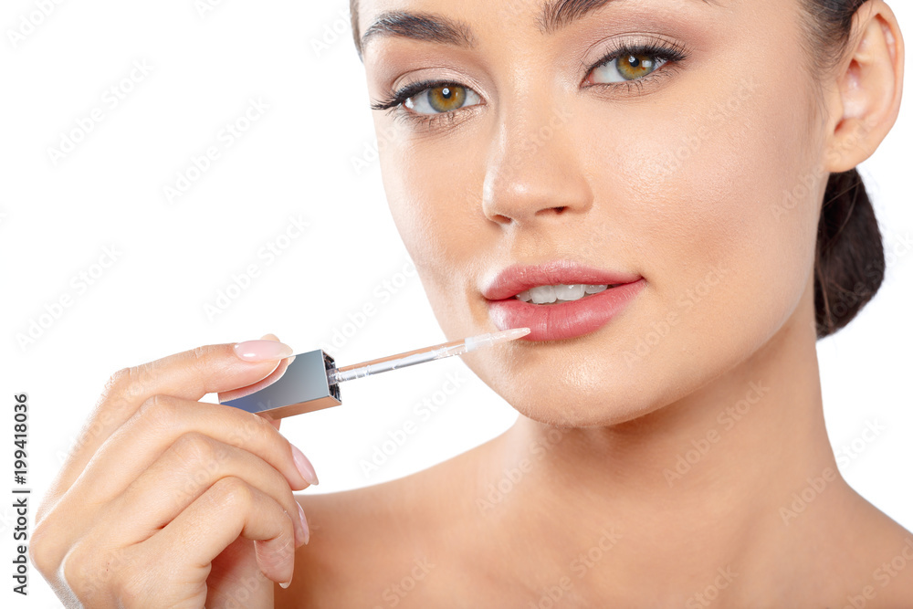 Beauty portrait of a playful beautiful half naked woman applying make-up with a brush Beauty portrait of a playful beautiful half naked woman applying make-up with a brush