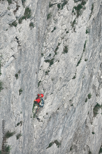 man rock climber climbs on the cliff