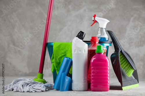 Cleaning supplies on grey background