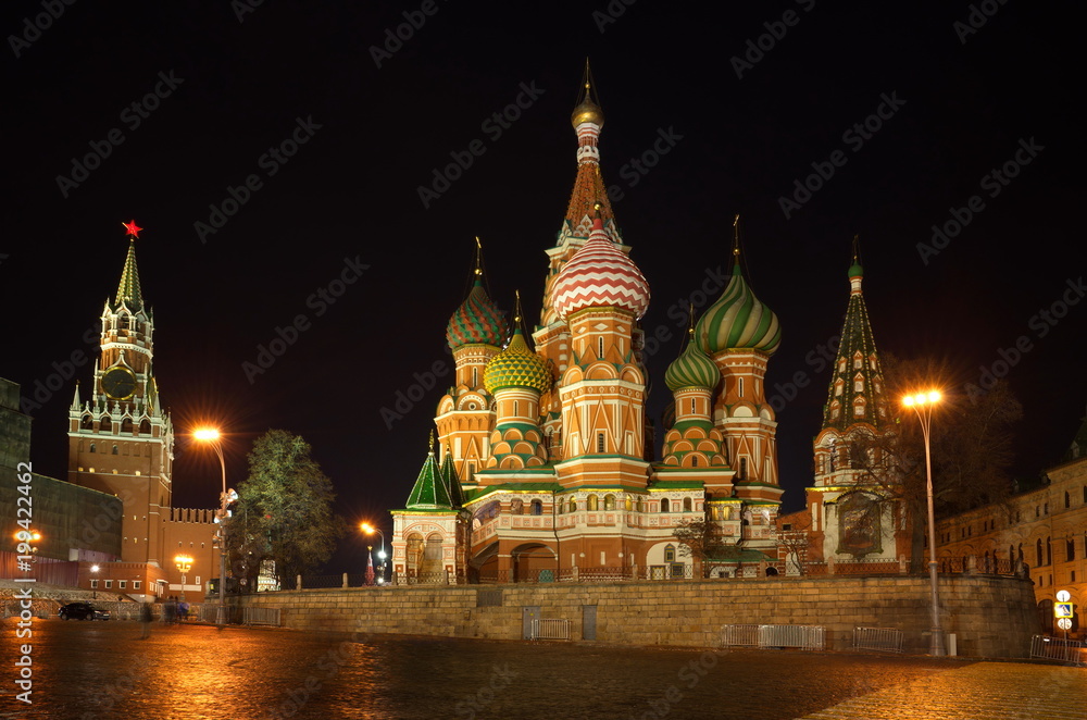 Cathedral of the Intercession of the virgin on the Moat (St. Basil's Cathedral) and the Spasskaya tower of the Moscow Kremlin in the winter evening, Russia