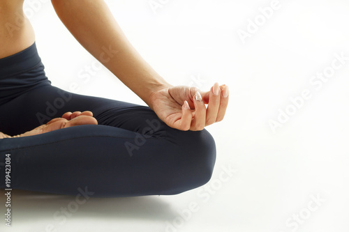 Close up hands of a young woman doing yoga.