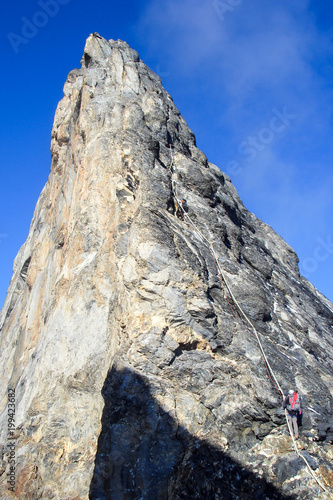 mountain climbers on the famous Mittellegi Ridge of Eiger mountain near Grindelwald in the Swiss Alps