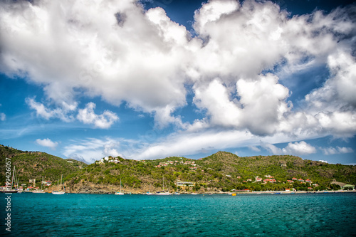 Holiday destination while travelling and wanderlust. Mountain shore in blue sea on cloudy sky in gustavia  st.barts. Summer vacation on tropical island. Wild nature and environment  ecology