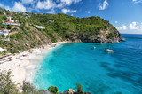 Harbor with sand beach, blue sea and mountain landscape in gustavia, st.barts. Summer vacation on tropical beach. Recreation, leisure and relax concept. Wanderlust and travel with adventure.