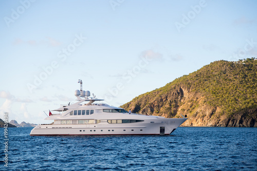 Yacht at sea coast on sunny blue sky in gustavia, st.barts. Yachting and sailing adventure. Luxury travel and voyage on boat. Summer vacation on tropical island. Water transport and marine vessel © be free