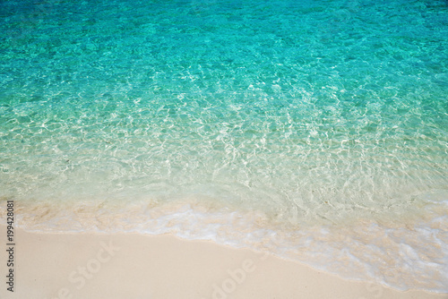 Wave of tropical sea beach on white sand