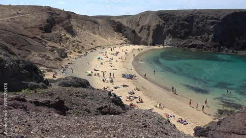 Tourists sunbathing on the beach in Playa de Papagayo Lanzarote Spain