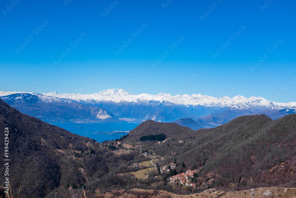 panorama on the Alps and Lake Maggiore from the Lombard pre-Alps, valley of woods and small villages