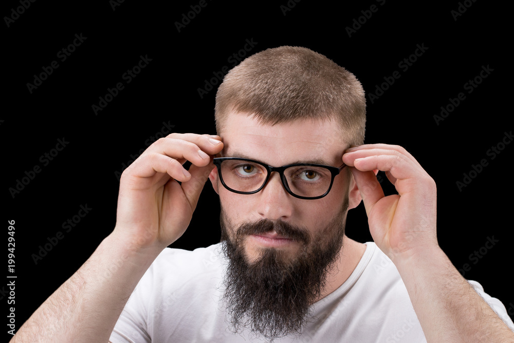 Cheerful smiling young businessman touching his glasses Cheerful smiling young businessman touching his glasses