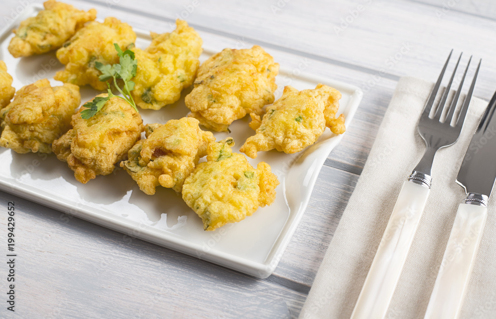 Cod fritters with cutlery. Spanish food. Cod fritters with cutlery. Spanish food.