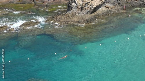 Swimmer in the blue sea in Playa de Papagayo Lanzarote Spain