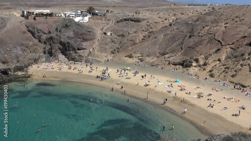 White sandy beach next to blue sea in Playa de Papagayo Lanzarote Spain