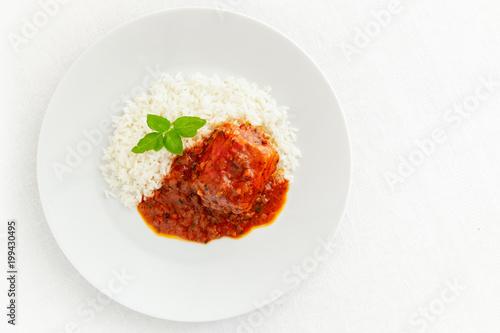 rabbit stewed in white wine, tomato, onion, and garlic sauce with basil garnished with rice 