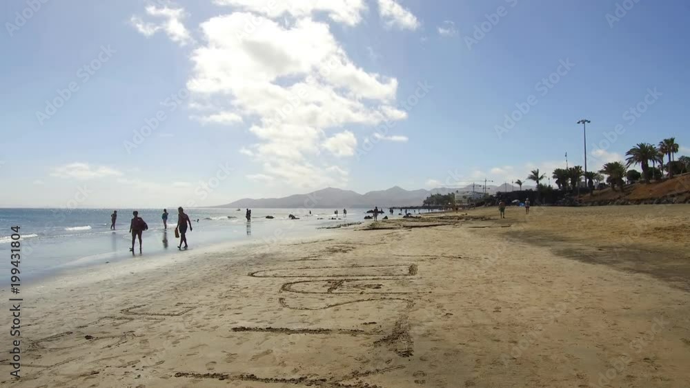 Walking on the sandy white beach in Puerto del Carmen Lanzarote Spain Walking on the sandy white beach in Puerto del Carmen Lanzarote Spain